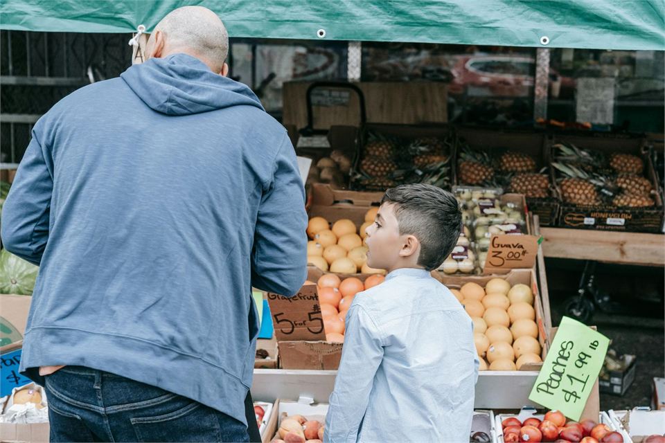 Parent and child shopping for groceries together